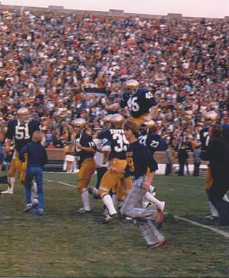 Rudy carried off field